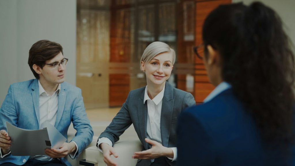 Business professionals discussing documents in a modern office