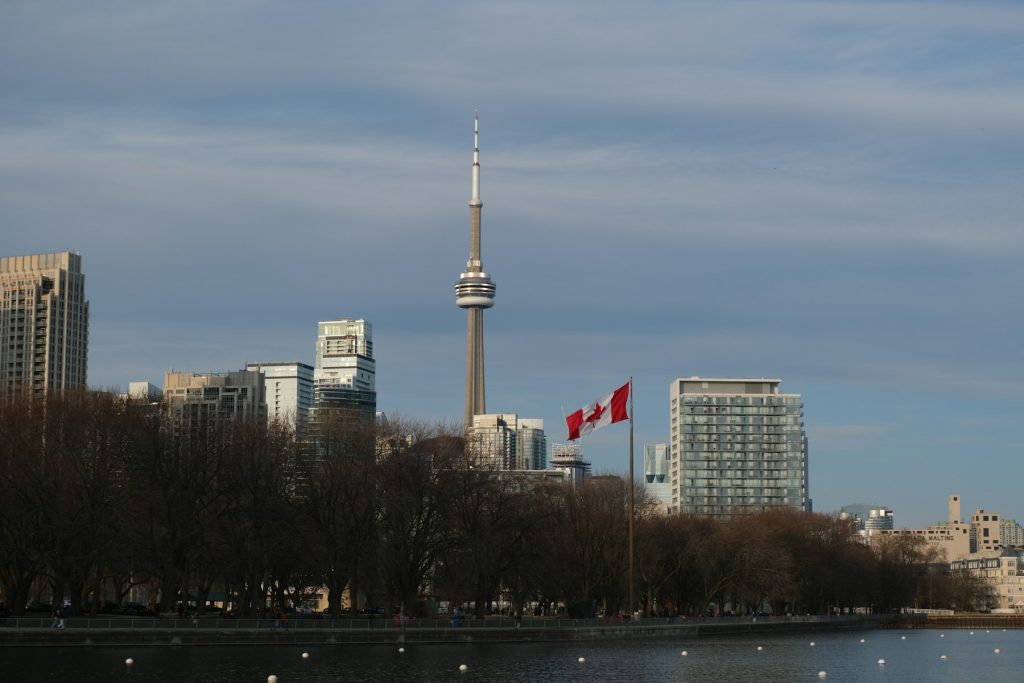 Toronto skyline with a Canadian flag representing immigration to Canada