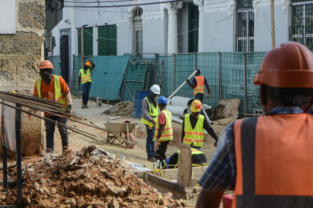 Skilled construction workers wearing hard hats and safety vests